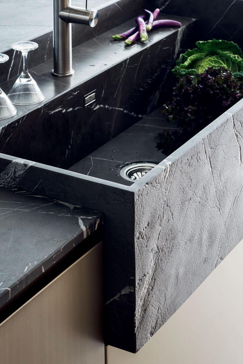 Luxury Italian Stone Sink by TMItalia – Modern Kitchen Design Close-up of a luxury Italian stone sink with elegant finishes and fresh vegetables, featured in a TMItalia modern kitchen design showroom in Naples, FL